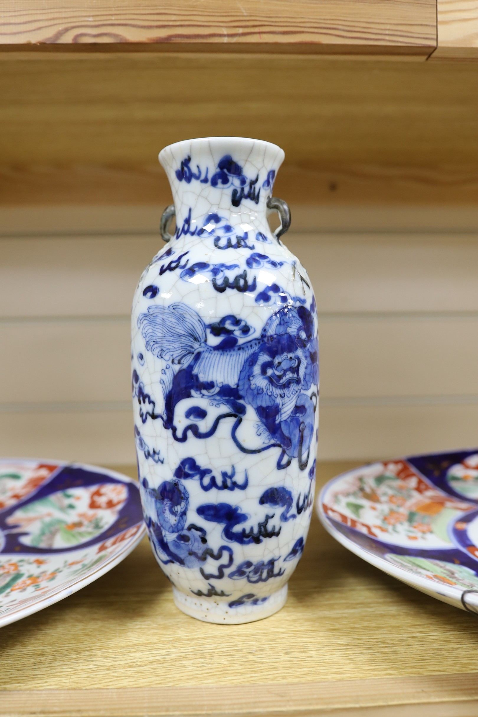 A Chinese two handled crackle glaze vase, Kangxi mark, but late 19th century, together two Imari plates, 37cm diameter